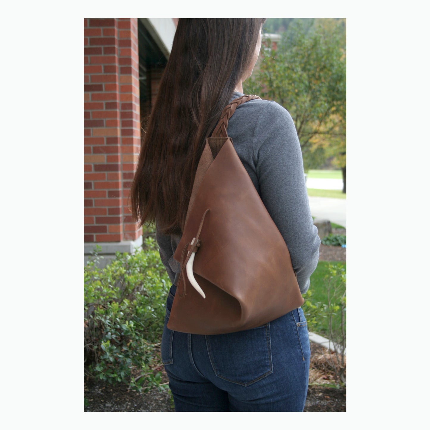 Rustic leather bag with antler tip decoration made in USA.