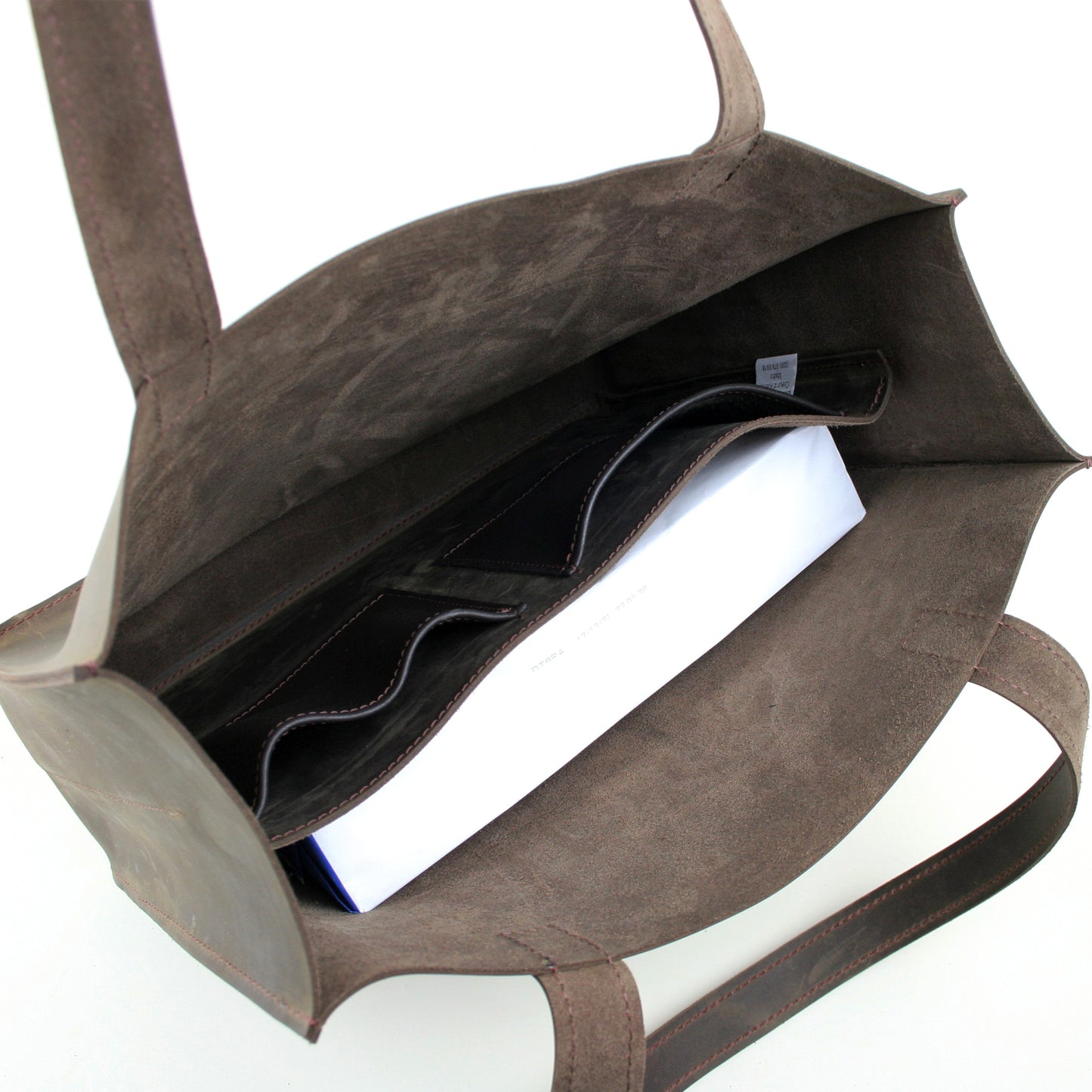 Interior shot of leather tote showing inside pockets.