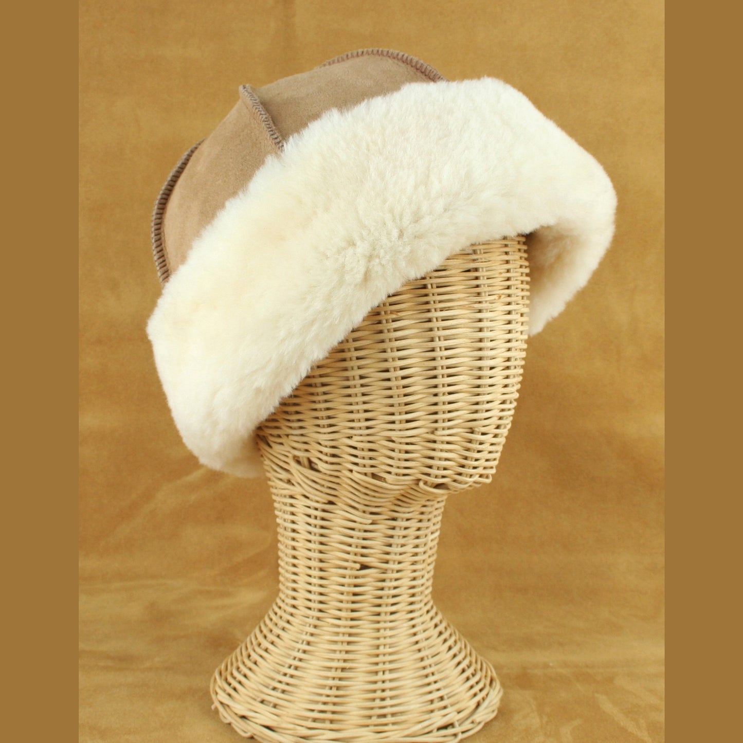 Sheepskin hat with cream colored brim made in the USA.