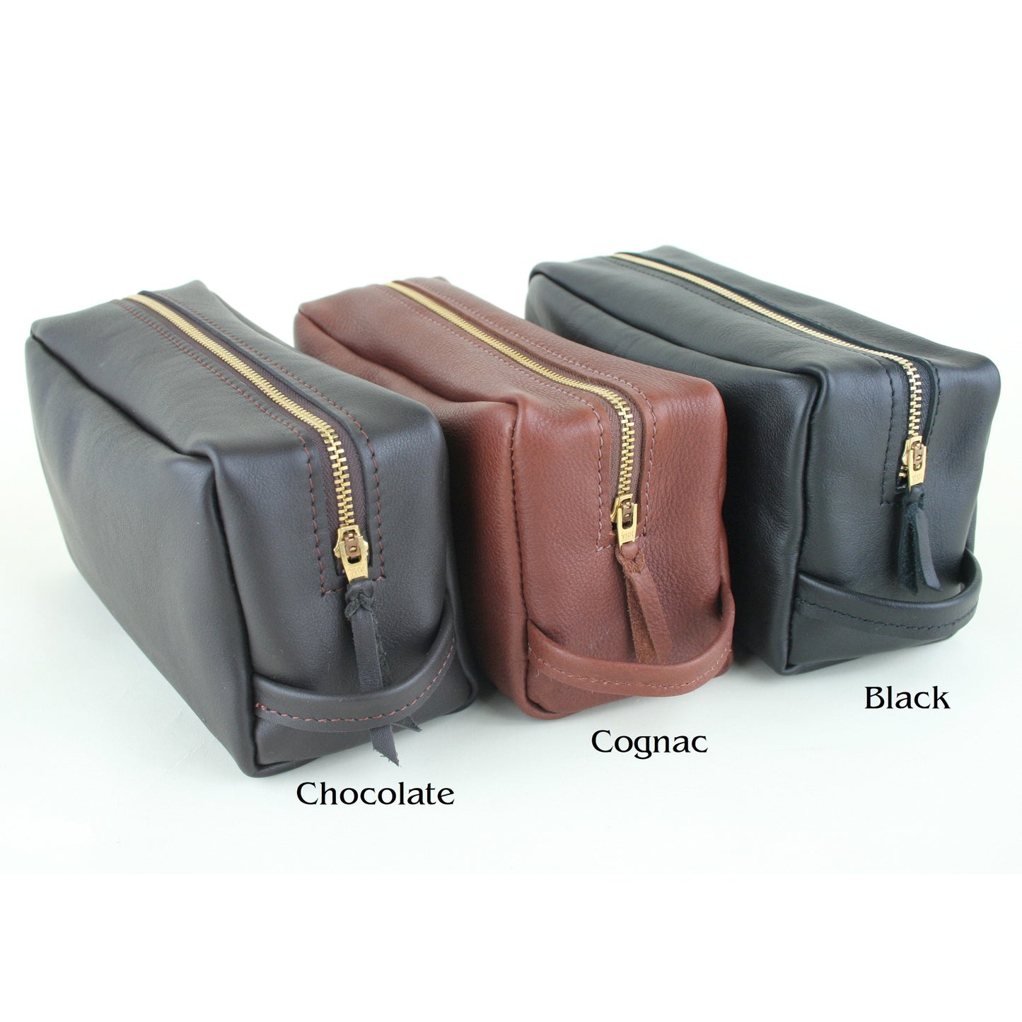 Different colors of leather toiletry bags.