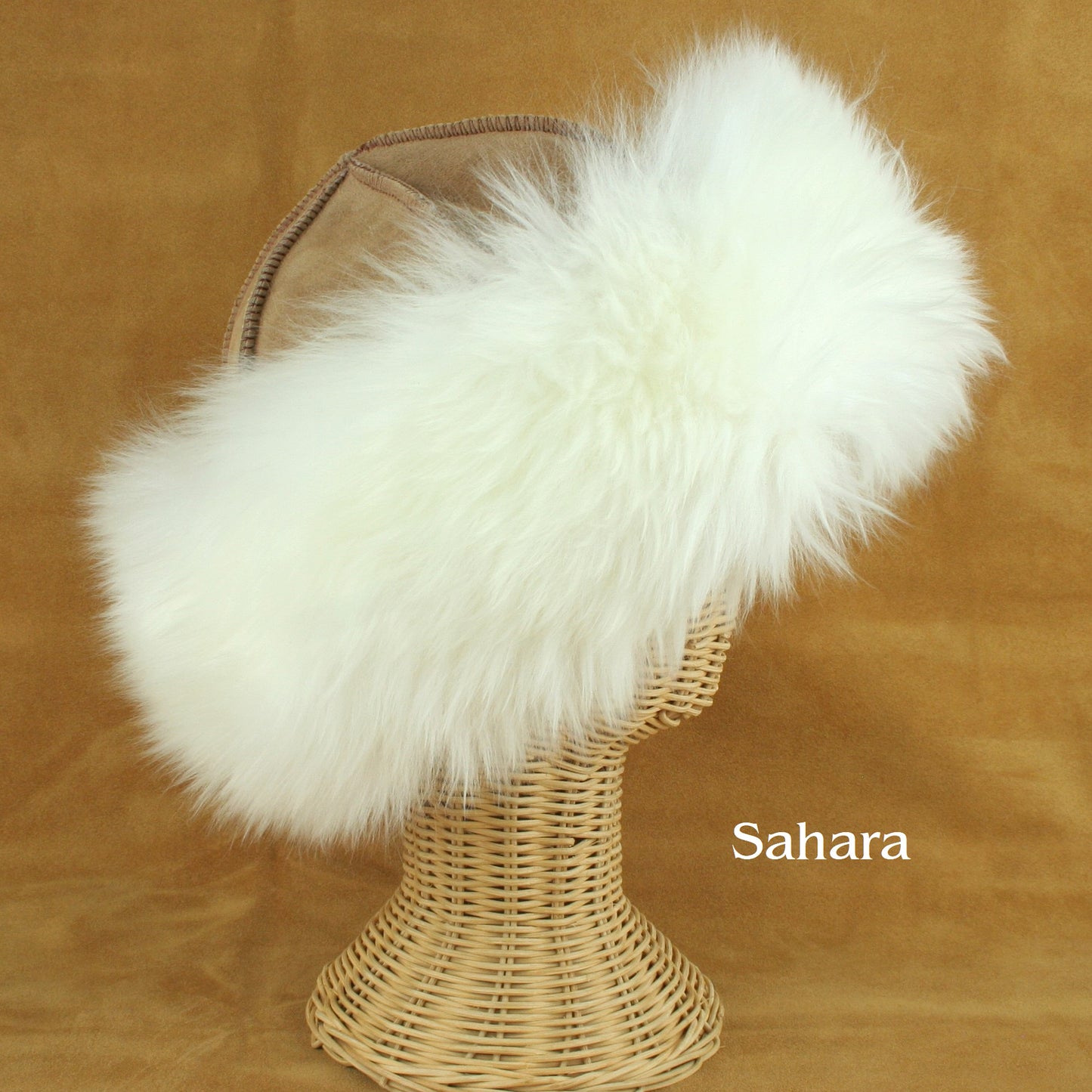 Brown sheepskin hat with fluffy white wool brim.