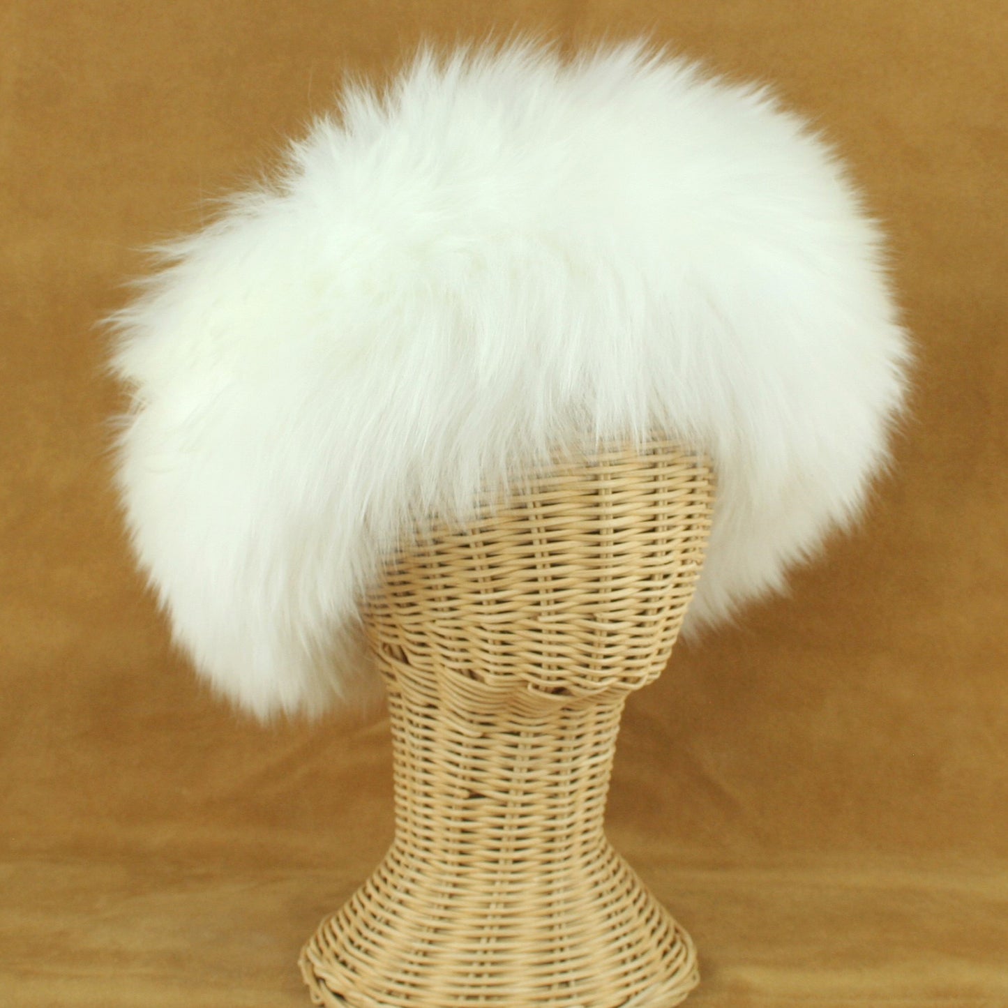 Sheepskin hat with long white fur.