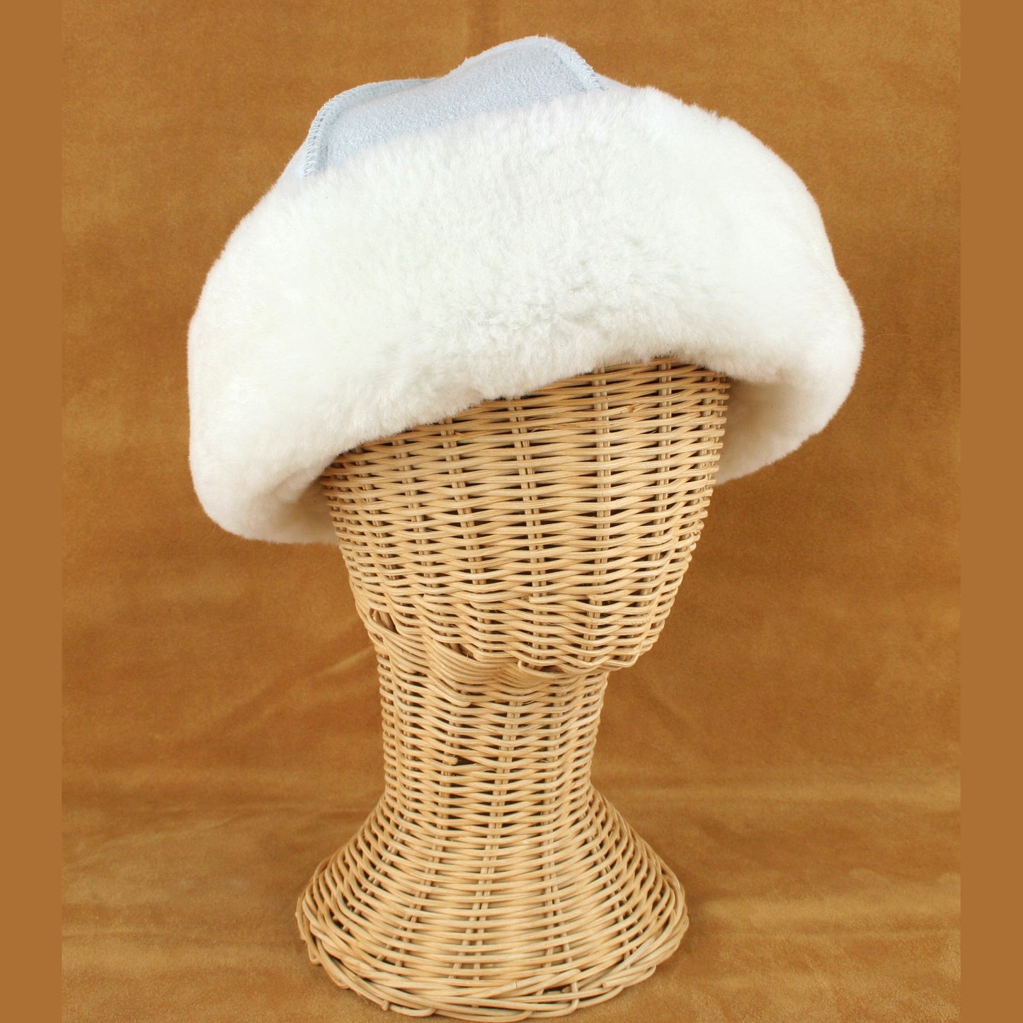 Sheepskin hat with white brim.