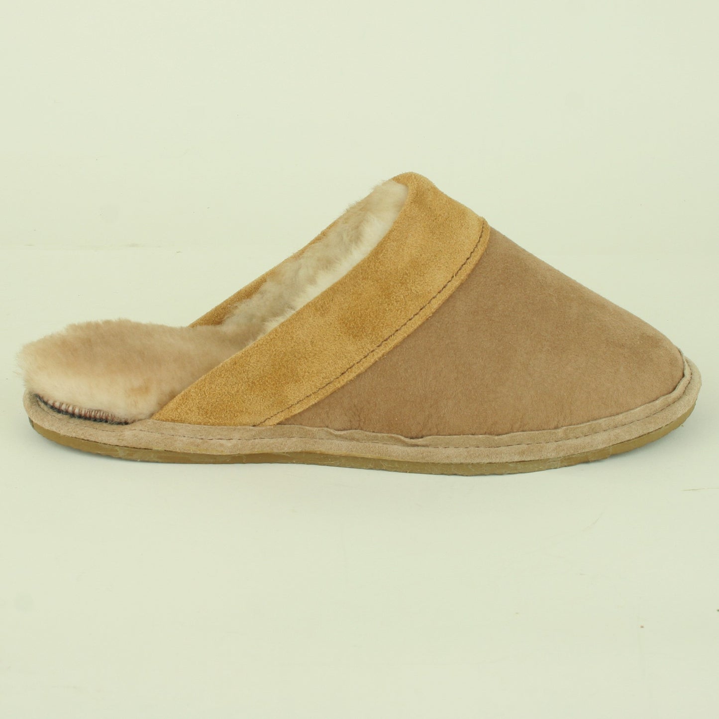 Side view of men's sheepskin scuff style slipper.