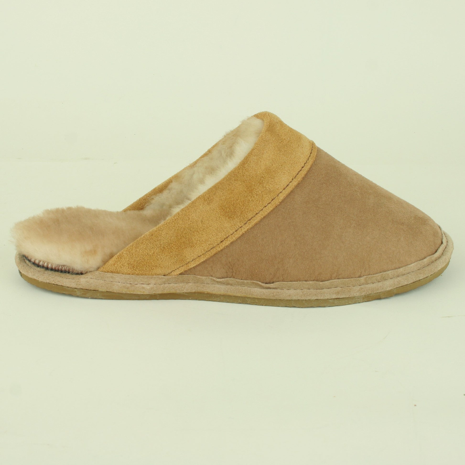 Side view of men's sheepskin scuff style slipper.