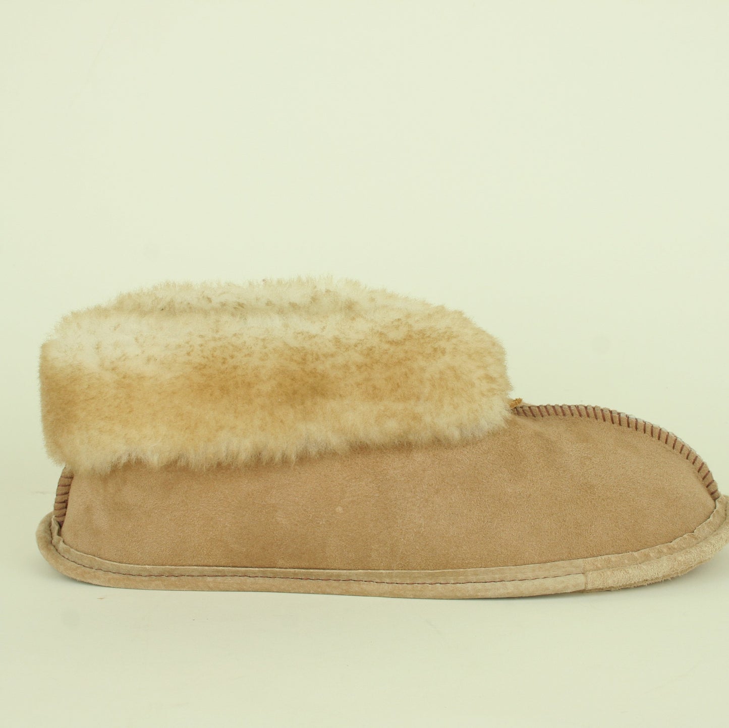 Side view of men's sheepskin slippers.